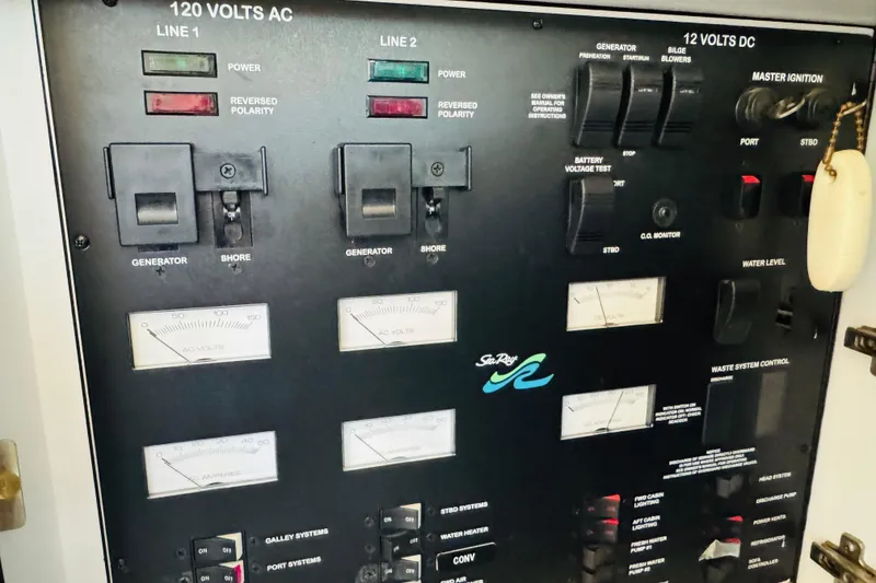 Slide: The Image of Control panel of a 2000 Sea Ray 400 Sedan Bridge yacht, showing electrical switches and gauges. - 66