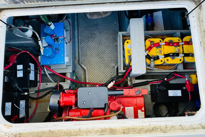 Slide: The Image of Engine compartment of a 2000 Sea Ray 400 Sedan Bridge with batteries and wiring. - 69