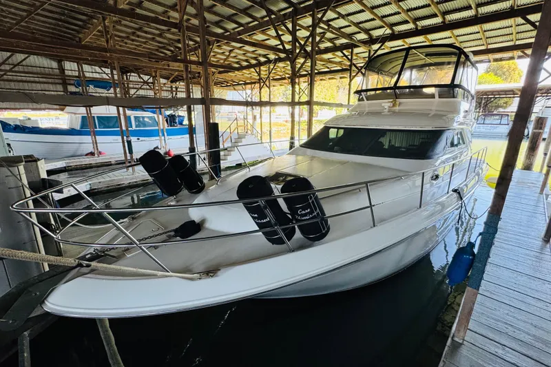 Slide: The Image of 2000 Sea Ray 400 Sedan Bridge yacht docked in a covered marina. - 7