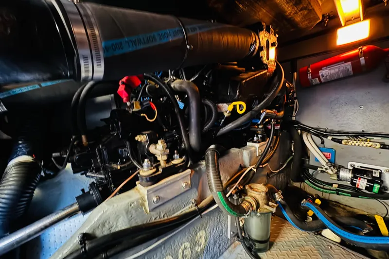 Slide: The Image of Engine room of a 2000 Sea Ray 400 Sedan Bridge, showcasing mechanical components and wiring. - 70