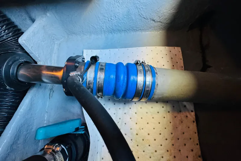 Slide: The Image of Engine compartment of a 2000 Sea Ray 400 Sedan Bridge with blue hose and clamps. - 72