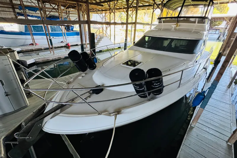 Slide: The Image of 2000 Sea Ray 400 Sedan Bridge yacht docked in a covered marina. - 8