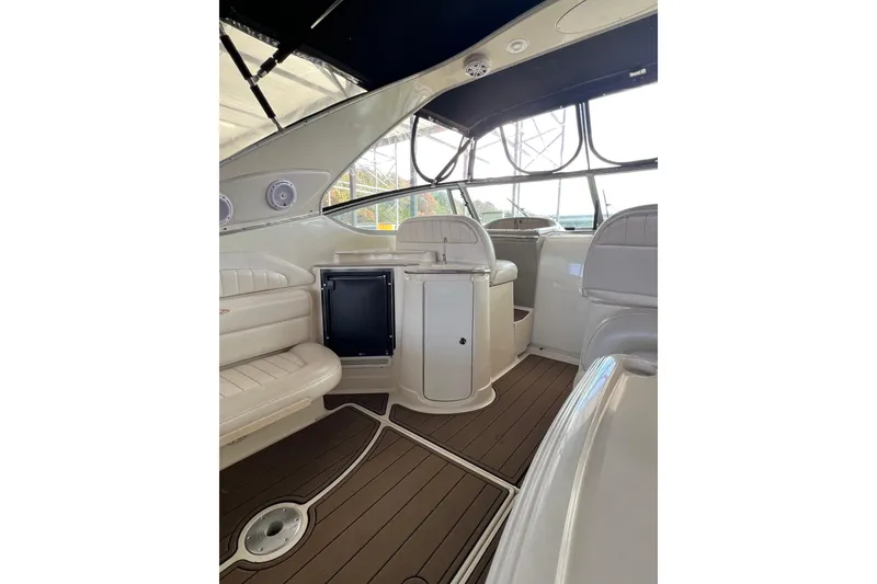 Slide: The Image of 1998 Maxum 4100 SCR yacht interior with beige seating and wood flooring. - 10