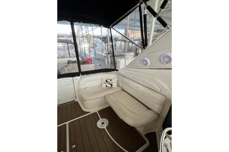 Slide: The Image of 1998 Maxum 4100 SCR boat interior with beige seating and wood-style flooring. - 11