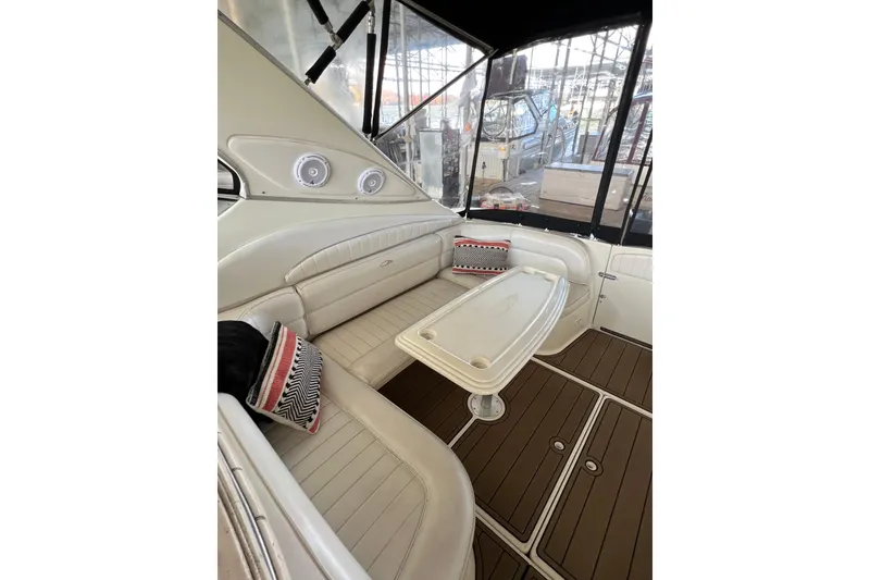 Slide: The Image of Interior of 1998 Maxum 4100 SCR yacht with cushioned seating and table. - 12