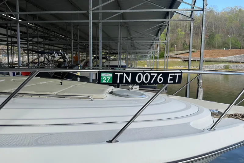 Slide: The Image of 1998 Maxum 4100 SCR boat docked, displaying registration number TN 0076 ET. - 2