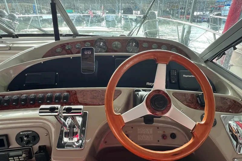 Slide: The Image of 1998 Maxum 4100 SCR boat helm with wooden steering wheel and control panel. - 5