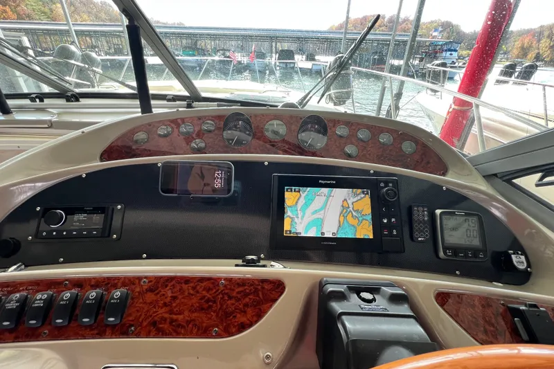 Slide: The Image of 1998 Maxum 4100 SCR boat dashboard with navigation system and controls. - 7