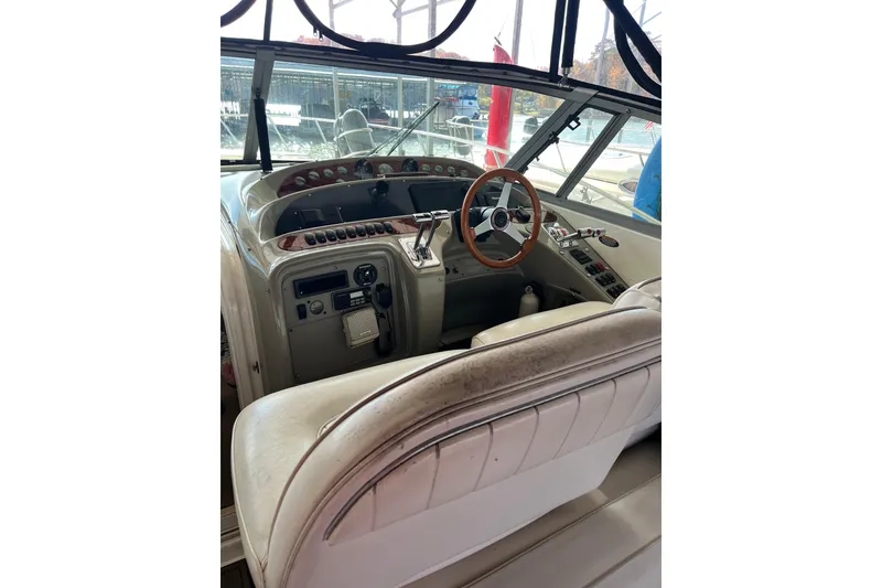Slide: The Image of 1998 Maxum 4100 SCR boat cockpit with steering wheel and control panel. - 8