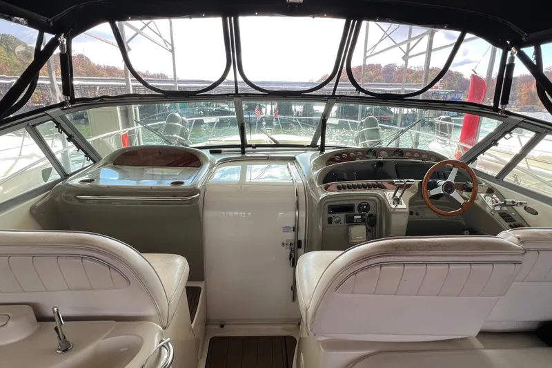 Slide: The Image of 1998 Maxum 4100 SCR yacht cockpit with steering wheel and control panel. - 9