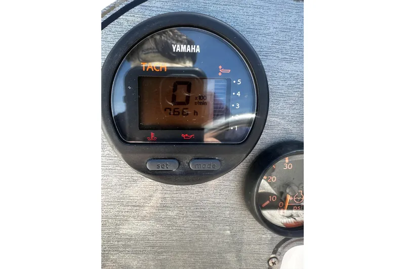 Slide: The Image of Yamaha tachometer on 2004 Aquasport 215 Osprey Sport boat dashboard. - 11