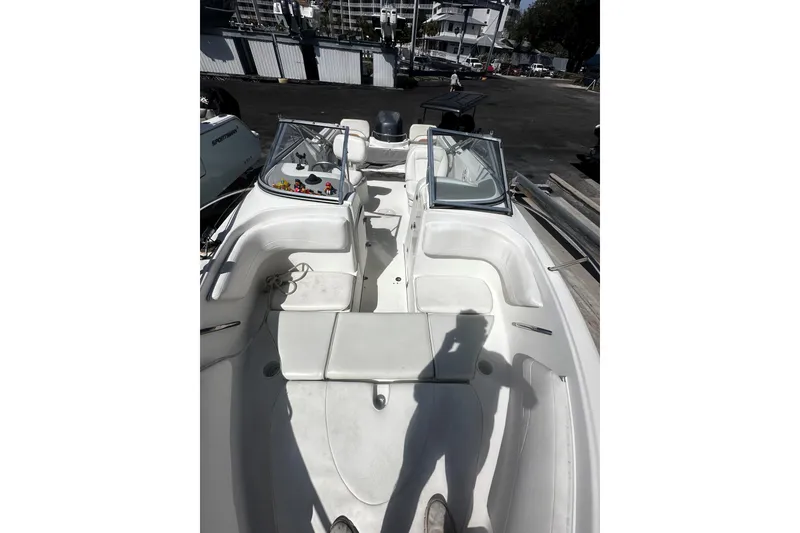 Slide: The Image of 2004 Aquasport 215 Osprey Sport boat interior with seating and open windshield. - 7