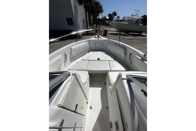 Slide: The Image of 2004 Aquasport 215 Osprey Sport boat interior with seating and storage compartments. - 9