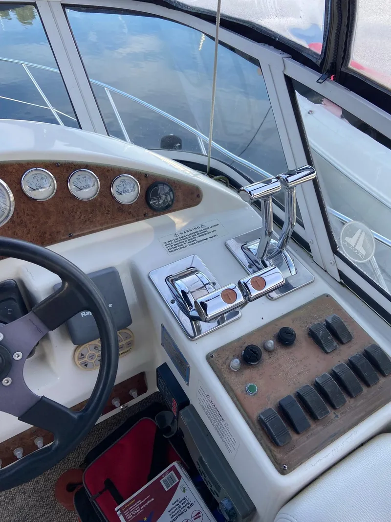 Slide: The Image of 2005 Silverton 330 Sport Bridge helm with gauges and controls. - 11