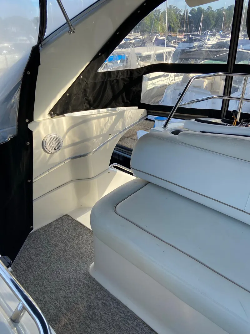 Slide: The Image of 2005 Silverton 330 Sport Bridge interior with speakers and cup holders at marina. - 13