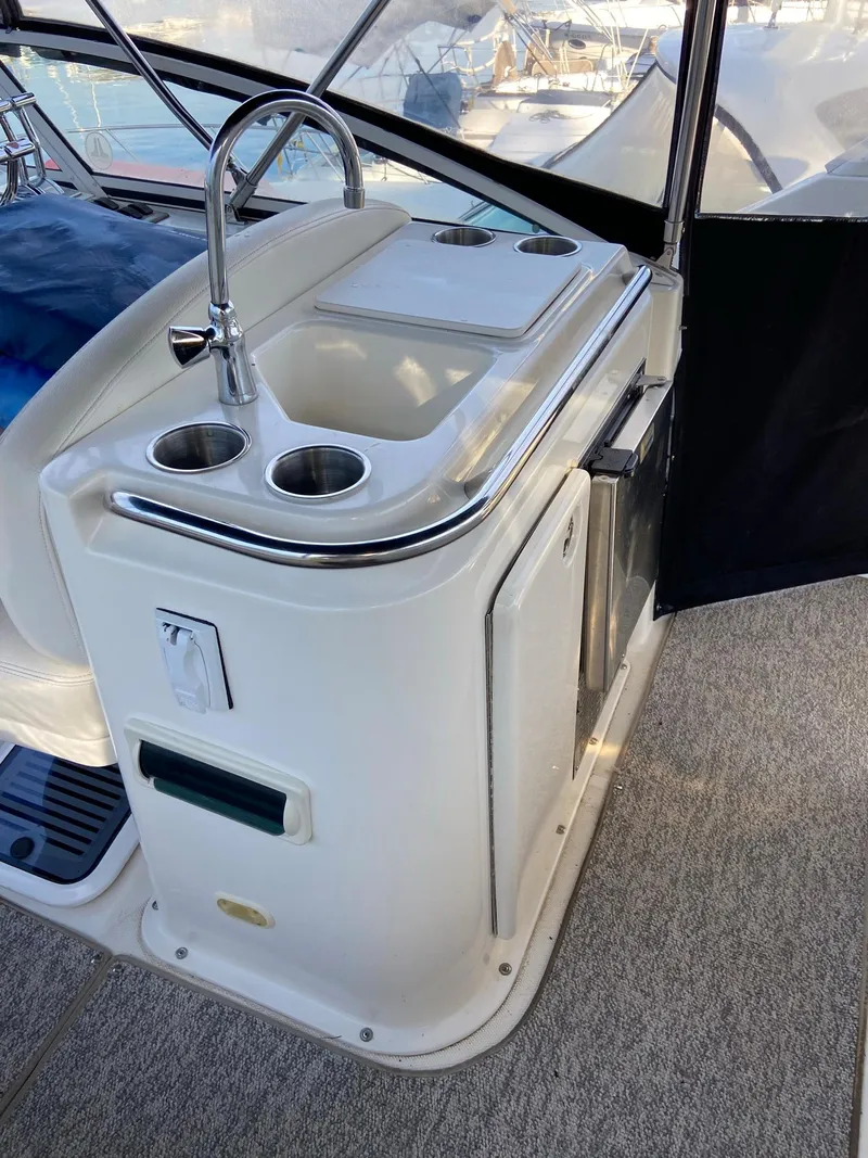 Slide: The Image of 2005 Silverton 330 Sport Bridge helm with steering wheel and navigation instruments. - 14