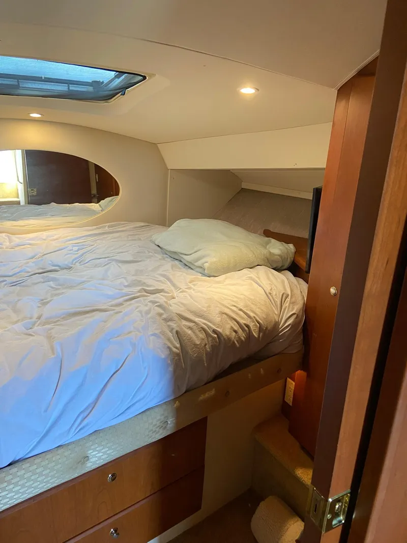 Slide: The Image of 2005 Silverton 330 Sport Bridge boat interior with mini fridge and cup holders. - 18