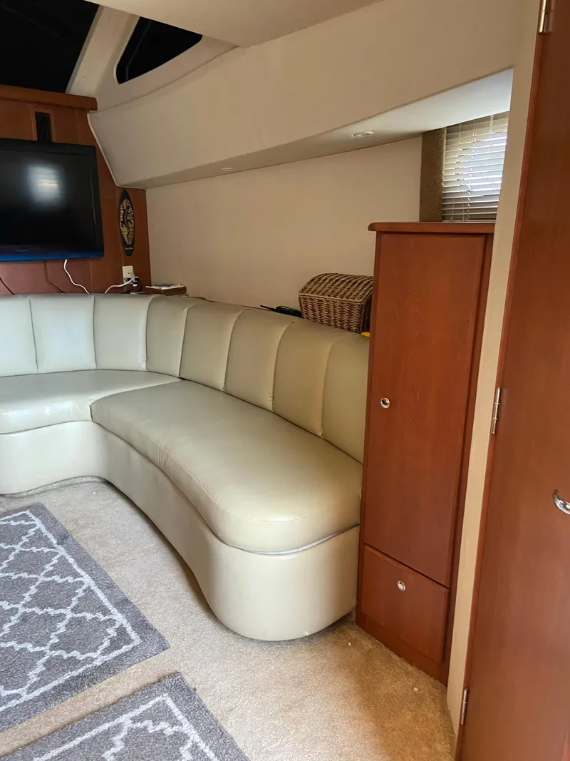 Slide: The Image of Interior of 2005 Silverton 330 Sport Bridge with nautical-themed cushions and dining area. - 24
