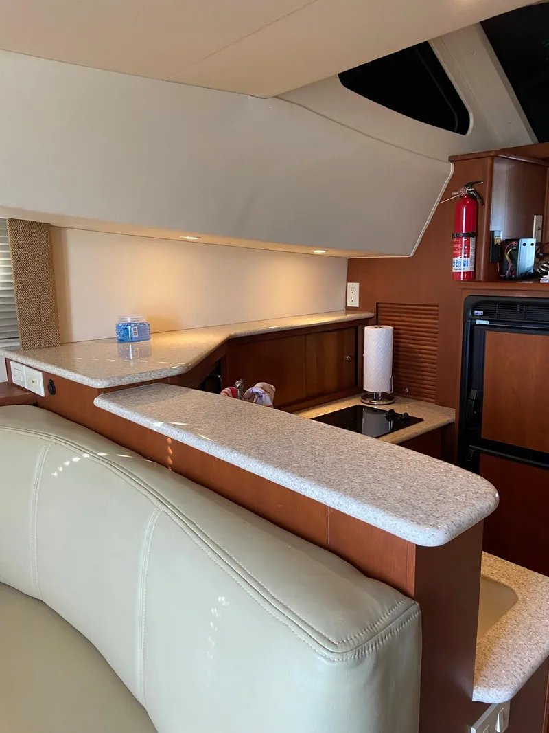 Slide: The Image of Interior of 2005 Silverton 330 Sport Bridge yacht with cozy seating and nautical decor. - 25