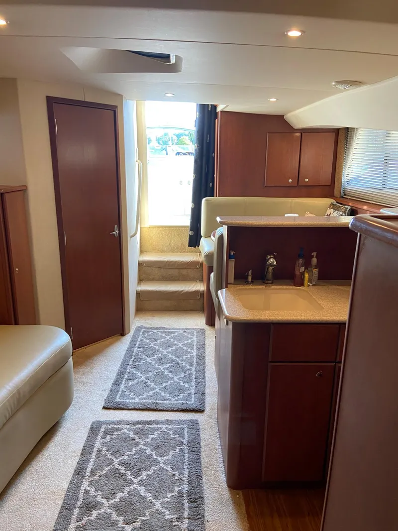 Slide: The Image of 2005 Silverton 330 Sport Bridge kitchen with sink, microwave, and electric stove. - 28
