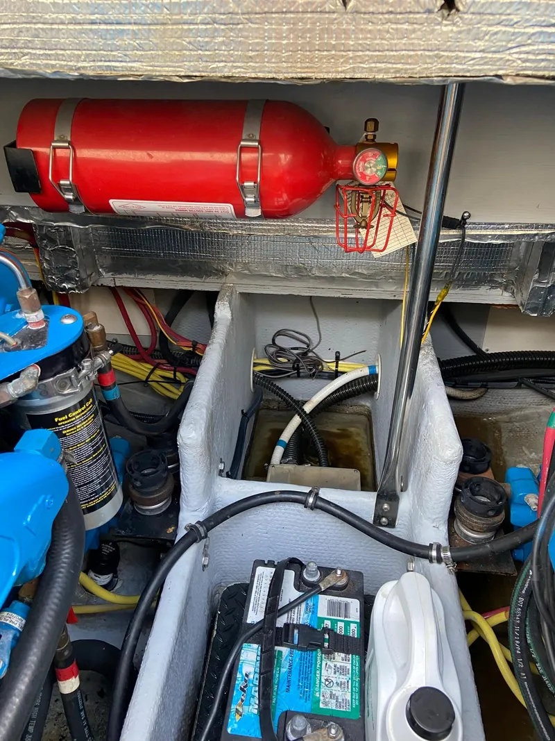 Slide: The Image of Engine room of 2005 Silverton 330 Sport Bridge with fire extinguisher. - 46
