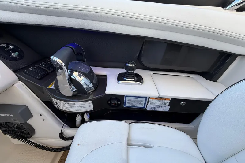 Slide: The Image of Control panel of a 2015 Sea Ray SLX 350 boat with throttle and joystick. - 11