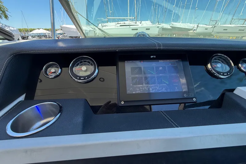 Slide: The Image of Dashboard of a 2015 Sea Ray SLX 350 boat with gauges and touchscreen display. - 12