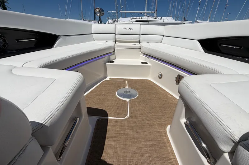 Slide: The Image of Luxurious interior of 2015 Sea Ray SLX 350 boat with white seating and wood flooring. - 14