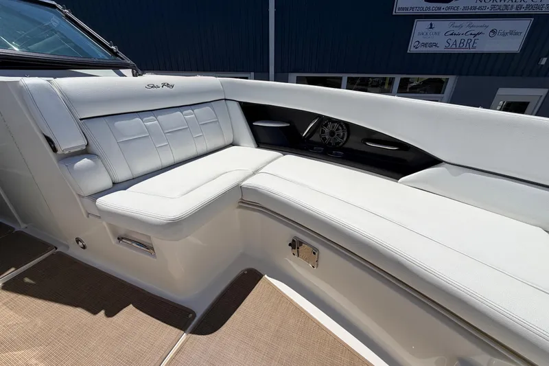 Slide: The Image of Luxurious seating on a 2015 Sea Ray SLX 350 boat, featuring white upholstery and sleek design. - 16