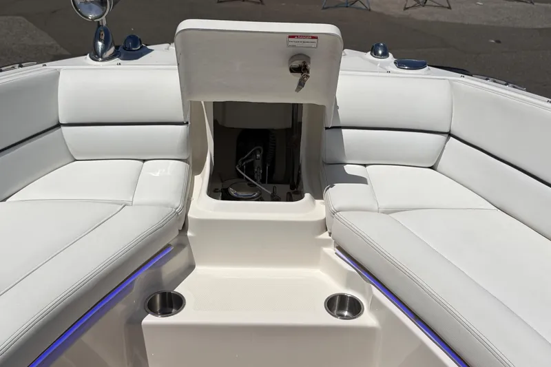 Slide: The Image of 2015 Sea Ray SLX 350 boat interior with white seating and storage compartment. - 17