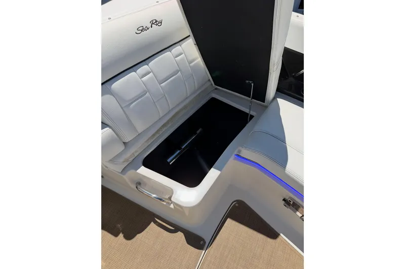Slide: The Image of 2015 Sea Ray SLX 350 boat interior storage compartment with white seating. - 19