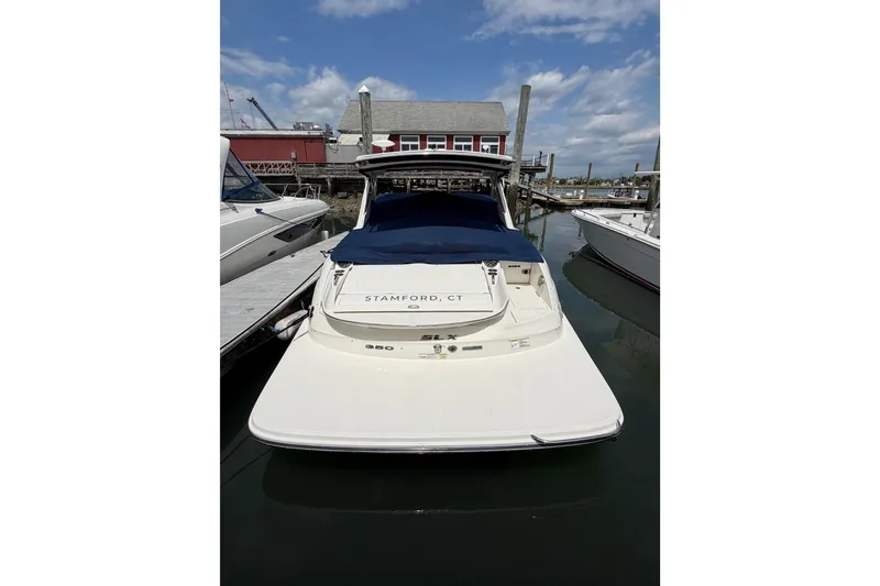 Slide: The Image of 2015 Sea Ray SLX 350 boat docked in Stamford, CT marina under a clear sky. - 2