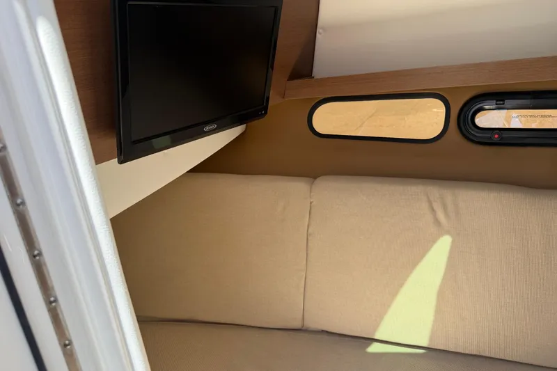 Slide: The Image of Interior of 2015 Sea Ray SLX 350 boat with TV and beige seating. - 21