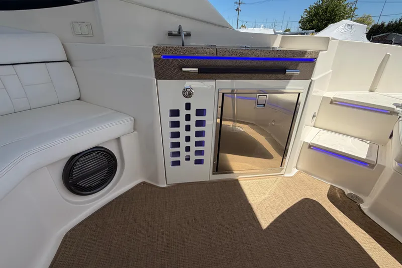 Slide: The Image of Interior of 2015 Sea Ray SLX 350 boat with seating, speaker, and mini-fridge. - 22