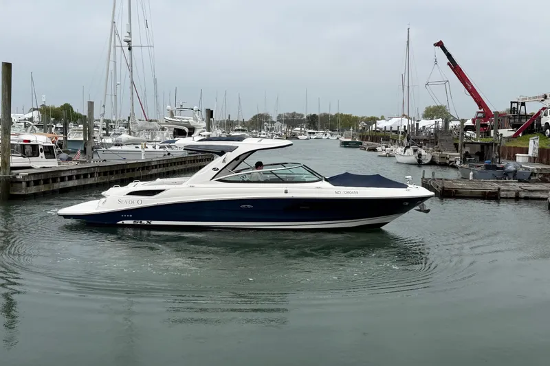 Slide: The Image of 2015 Sea Ray SLX 350 boat docked in a marina with surrounding yachts. - 3