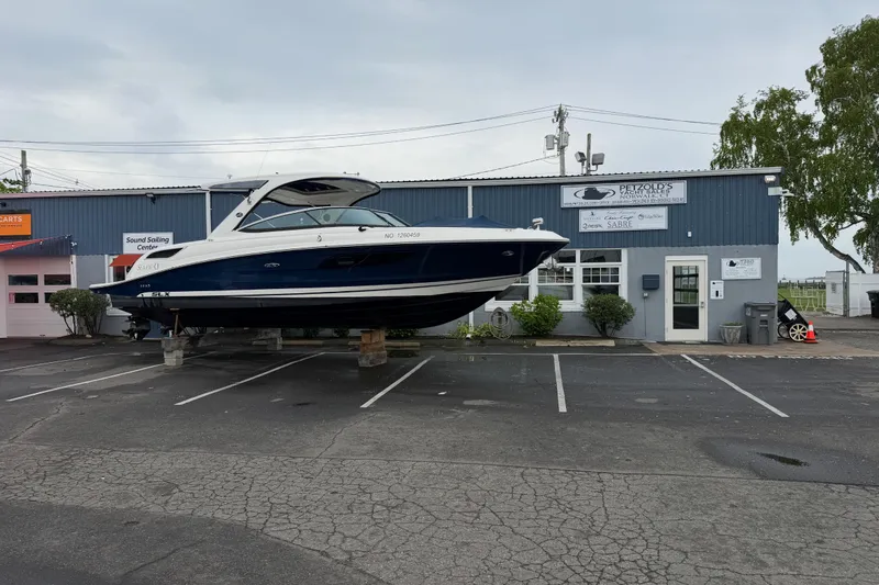 Slide: The Image of 2015 Sea Ray SLX 350 boat displayed outside a marine service center. - 4