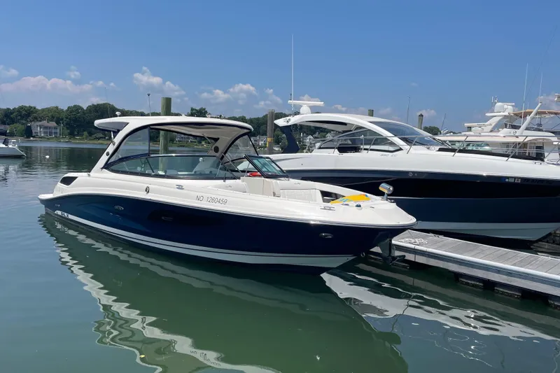 Slide: The Image of 2015 Sea Ray SLX 350 boat docked in a marina on a sunny day. - 5