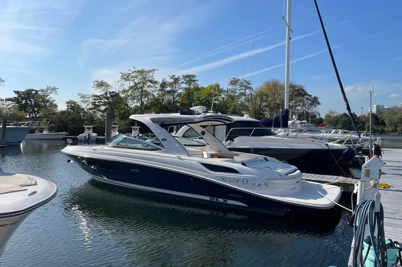 Slide: The Image of 2015 Sea Ray SLX 350 boat docked at marina under clear blue sky. - 8