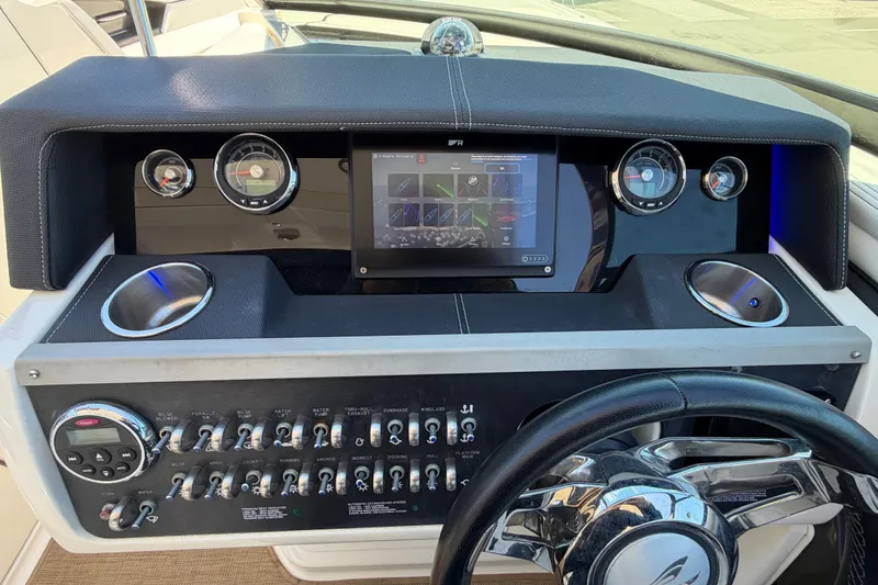Slide: The Image of Dashboard of 2015 Sea Ray SLX 350 boat with gauges, touchscreen, and controls. - 9