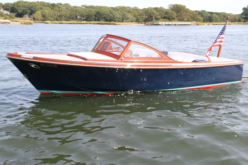 The Image of 2005 Limestone 24' Express Cruiser on calm water with American flag. - 0