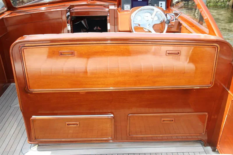 Slide: The Image of 2005 Limestone 24' Express Cruiser interior with polished wood finish and steering wheel. - 13