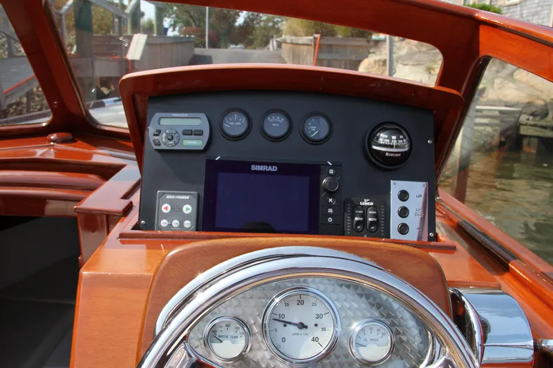 Slide: The Image of Dashboard of a 2005 Limestone 24' Express Cruiser with navigation instruments. - 17
