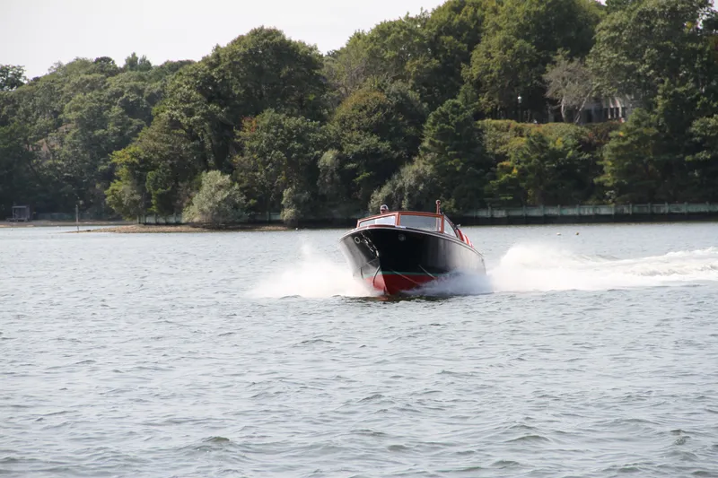 Slide: The Image of 2005 Limestone 24' Express Cruiser speeding on a scenic lake with lush green trees. - 18