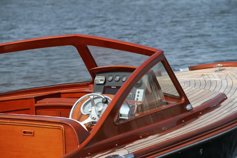 Slide: The Image of 2005 Limestone 24' Express Cruiser on calm water, featuring elegant wooden interior. - 2