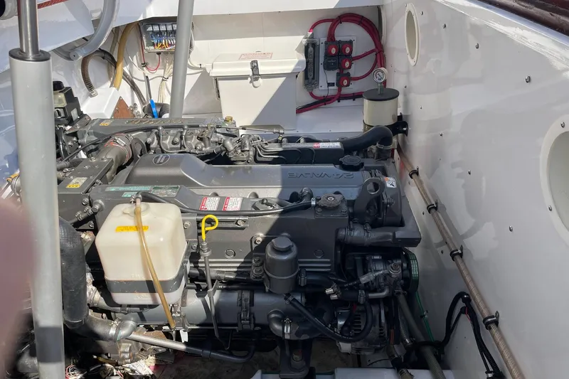 Slide: The Image of Engine compartment of a 2005 Limestone 24' Express Cruiser, showcasing detailed mechanical components. - 21