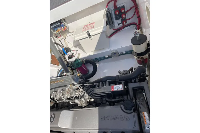 Slide: The Image of Engine compartment of a 2005 Limestone 24' Express Cruiser, showcasing mechanical components. - 22