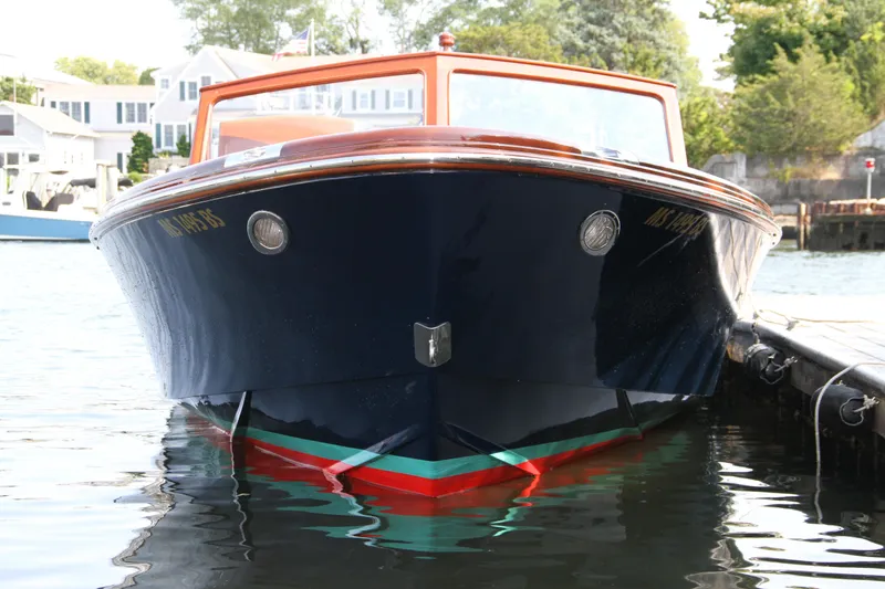 Slide: The Image of 2005 Limestone 24' Express Cruiser with American flag on water, named "Beacon Osterville". - 4