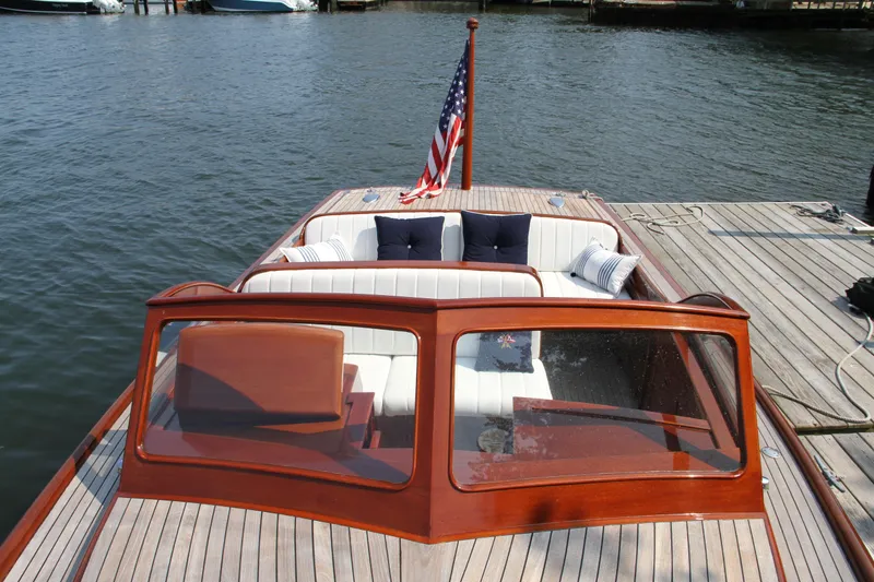 Slide: The Image of 2005 Limestone 24' Express Cruiser docked in a serene marina setting. - 5