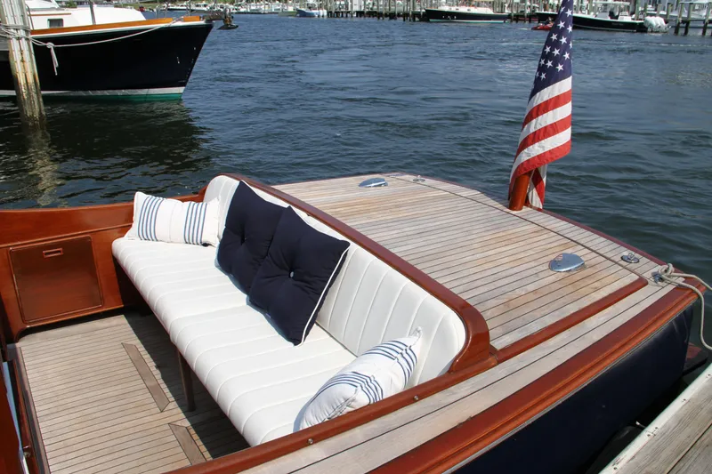 Slide: The Image of 2005 Limestone 24' Express Cruiser with elegant seating and American flag on deck. - 6