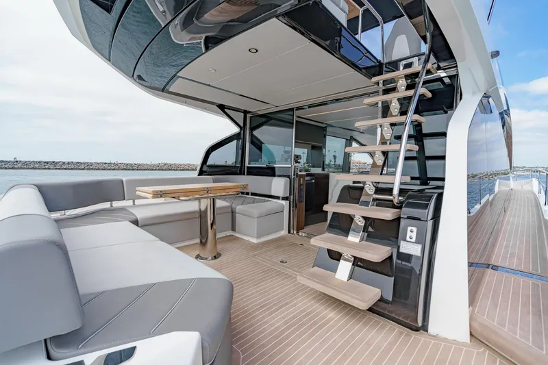 Slide: The Image of 2023 Sunseeker 65 Sport Yacht interior with modern seating and sleek staircase design. - 12